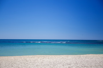 Sandy Beach on the Caribbean sea. Clear water, sand and blue sky