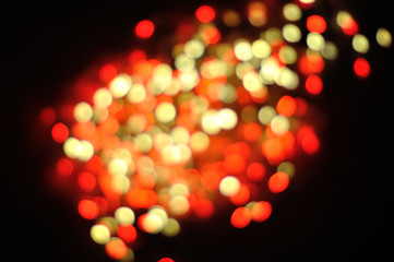 Bokeh defocused yellow and red lights on the black background