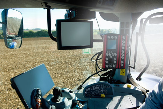 Farmer Driving Tractor Using Global Positioning System