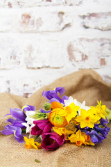 Fototapeta na wymiar Spring flower arrangement against a rustic background