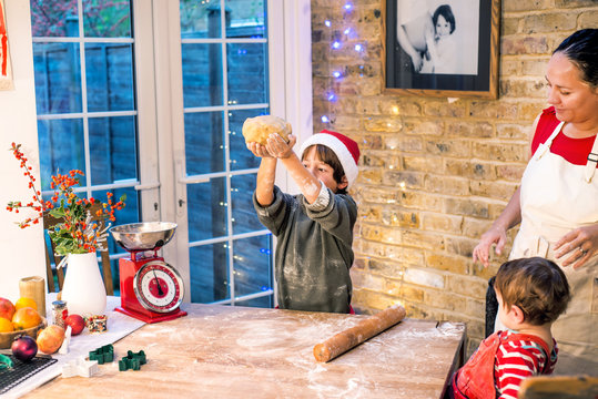 Mother and son making Christmas cookies at home