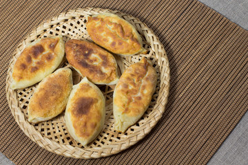 Fried pies in wicker plate on the table