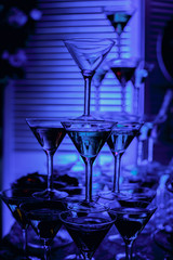 beautiful wine champagne glasses in front of colorful background with shades of  blue.