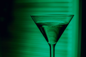 beautiful wine champagne glasse in front of colorful background with shades of green.