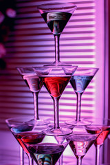 beautiful wine champagne glasses in front of colorful background with shades of  blue, red, green.