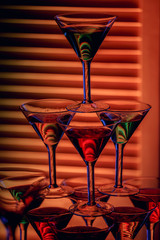 beautiful wine champagne glasse in front of colorful background with shades of red.
