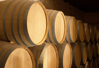 Wine barrels stacked in the cellar.