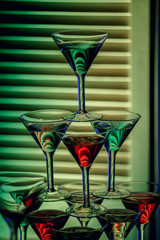 beautiful wine champagne glasse in front of colorful background with shades of green.