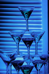 beautiful wine champagne glasse in front of colorful background with shades of blue. © Cheberkus
