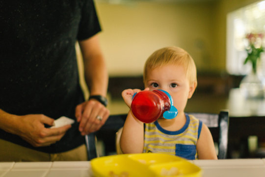 Young boy drinking from sippy cup