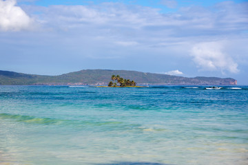 Tropical island with palm trees in the middle of the Caribbean sea.