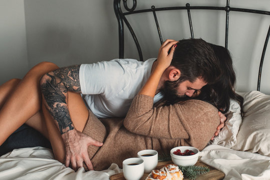 Passionate young couple with breakfast in bed