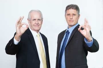 Portrait of confident men showing ok sign