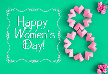 Fototapeta na wymiar Happy International Women’s Day celebrate on March 8 CARD. rose-color paper hearts shape figure eight on a green background 