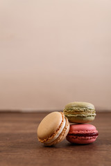 Macaroon cakes. Different types of macaron. Colorful almond cookies. French sweet dessert. Wooden rustic board.