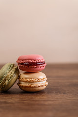 Macaroon cakes. Different types of macaron. Colorful almond cookies. French sweet dessert. Wooden rustic board.
