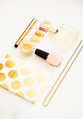 Woman's glamour make up products and accessories. Gold and white