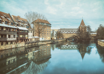 Winter landscape of fortification with a tower Fronveste Schlayerturm on Pegnitz river in Nuremberg, Bavaria, Germany