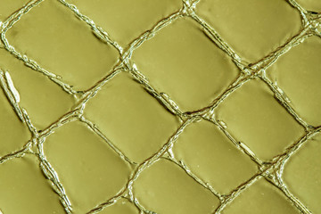 Texture of genuine leather close-up, embossed under the skin a khaki crocodile. For modern pattern,...