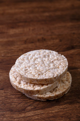 Rice biscuits on grunge rustic wood background. Natural organic diet food. Wooden vintage board.