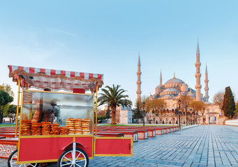Traditional turkish fast food cart at Blue Mosque Cami background. Morning scene. Classical Istanbul city center scenery, Turkey.