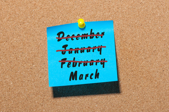 A conceptual image of spring beggining. Inscription March month and crossed out winter monthes December, January, February on blue sticker