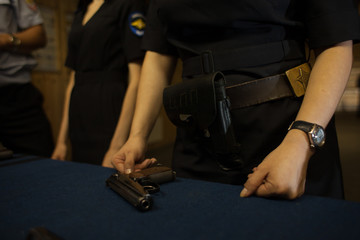 Hands and gun police woman