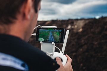 A man Operating The Drone By Remote Control In The Park