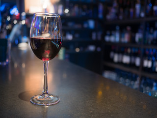 full glass of wine standing at the bar