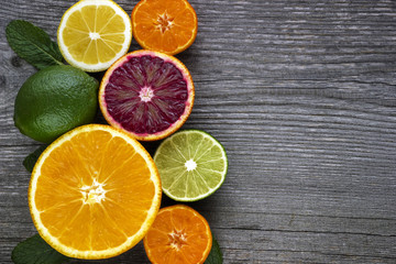 Naklejka na ściany i meble Lemon,red orange, orange, grapefruit, lime on old wooden table. Background.