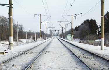 Winter view of empty railroad track in perspective. Horizontal composition of railway.