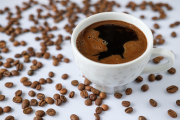 Cup of black coffee on the background of coffee bean