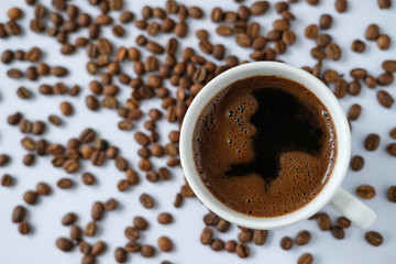Cup of black coffee on the background of coffee bean