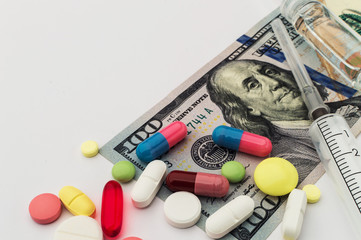 Colored pills with money. Health costs a lot