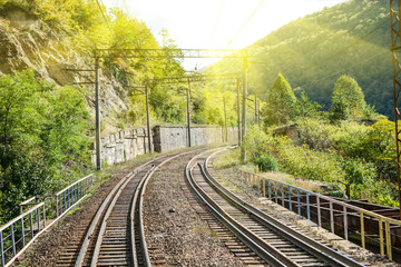 The high mountain railway road in the sunny day, Caucasus nature, travel and ecological concept