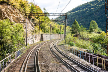 The high mountain railway road in the sunny day, Caucasus nature, travel and ecological concept