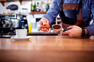 Hands bartender baristas make coffee cocoa cappuccino.