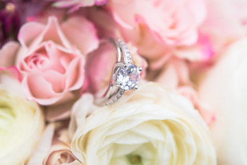 wedding rings with pastel pink rose