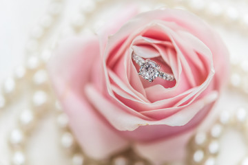 wedding rings with pastel pink rose