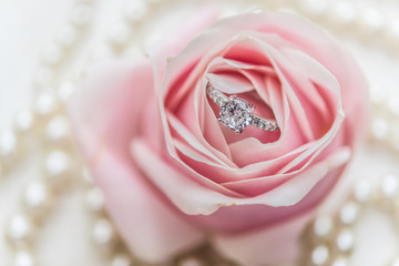 wedding rings with pastel pink rose
