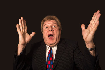 The surprised senior businessman on black