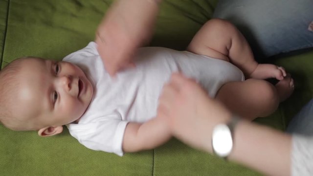 Mom plays with her litle baby