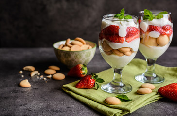 Delicious strawberry tiramisu with sponge biscuits in a glass jar