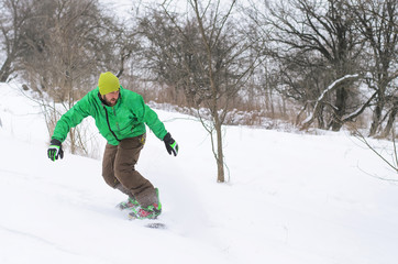 Fototapeta na wymiar Active man snowboarding.