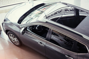 of the car in the spacious showroom with large windows