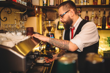 Barista preparing coffee in espresso machine