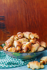 Bowl full of homemade fresh cookies on wooden background with copy space.