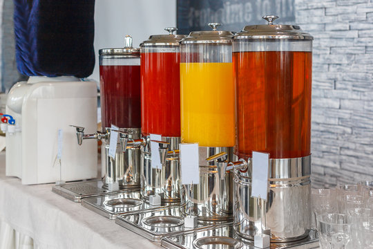 Breakfast buffet, Apple, orange and tomato juice in glass carafes to food