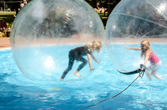 two children playing in super ball in swimming pool