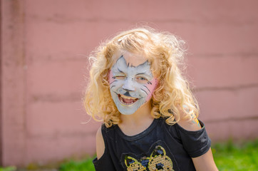 child with kitty face-painting